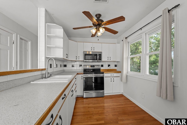 1612 Harbour View Dr Lot 114, Kill Devil Hills, NC 27948 - kitchen with stainless steel appliances, a sink, open shelves, backsplash, and light countertops