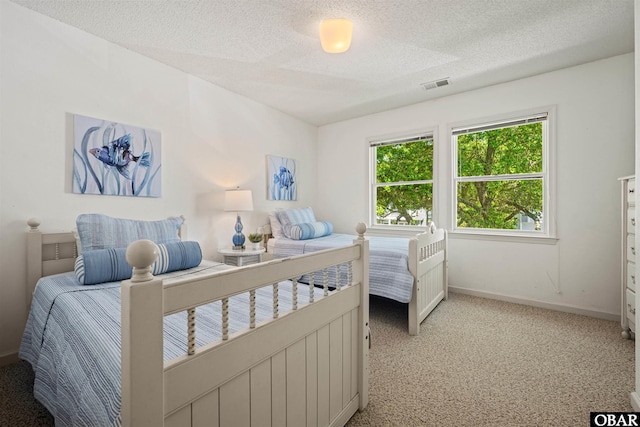506 Magnolia Way Lot 29, Corolla, NC 27927 - bedroom with a textured ceiling and light carpet