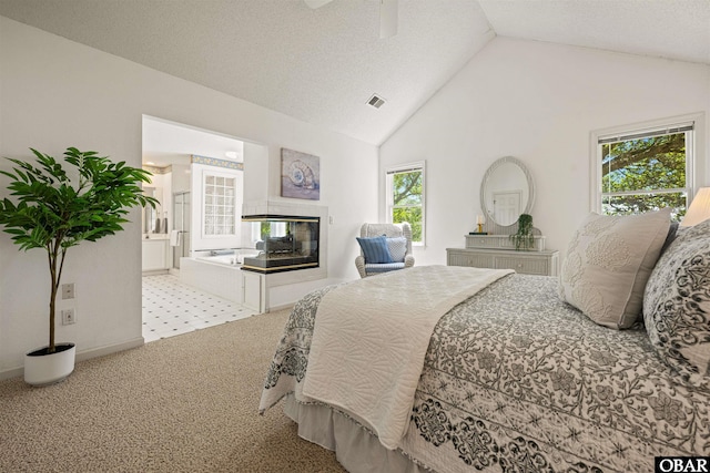 506 Magnolia Way Lot 29, Corolla, NC 27927 - bedroom with lofted ceiling, carpet flooring, a multi sided fireplace, and ceiling fan