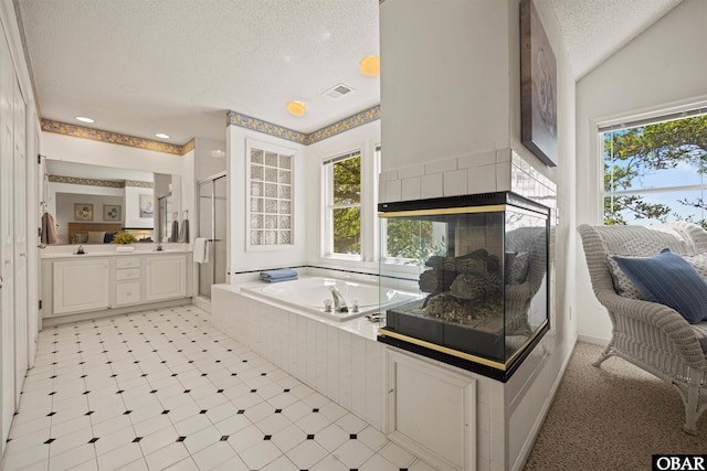 506 Magnolia Way Lot 29, Corolla, NC 27927 - bathroom featuring a textured ceiling, a shower stall, vanity, a bath, and recessed lighting