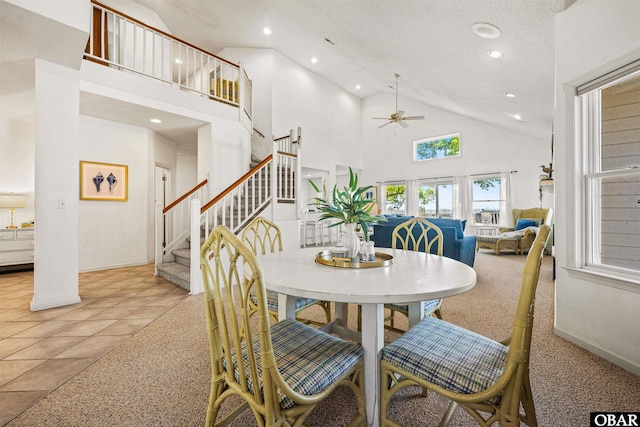 506 Magnolia Way Lot 29, Corolla, NC 27927 - carpeted dining room with high vaulted ceiling, a ceiling fan, stairs, recessed lighting, and tile patterned flooring