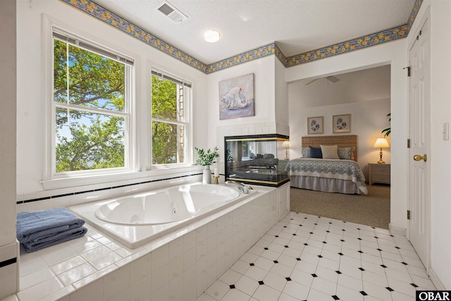 506 Magnolia Way Lot 29, Corolla, NC 27927 - ensuite bathroom featuring a tub with jets and a textured ceiling