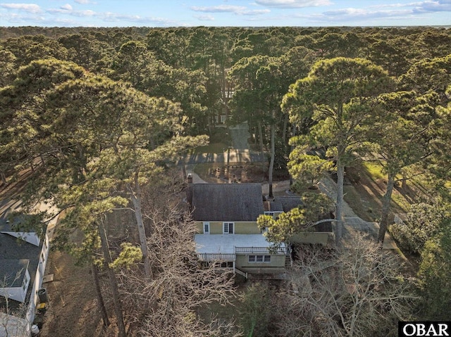 bird's eye view with a wooded view