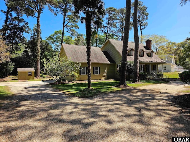 56 Deer Path Ln Lot 413, Southern Shores, NC 27949 - cape cod home featuring an outdoor structure, a shed, a chimney, and covered porch