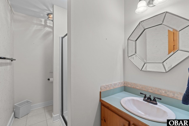 bathroom featuring tile patterned flooring, vanity, and baseboards