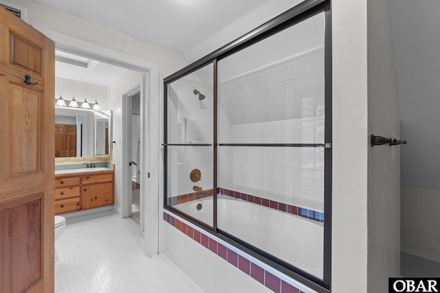 full bath with tiled shower / bath combo, vanity, and toilet