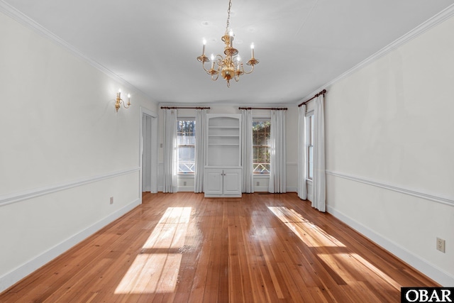 unfurnished bedroom with light wood-style flooring, baseboards, and ornamental molding