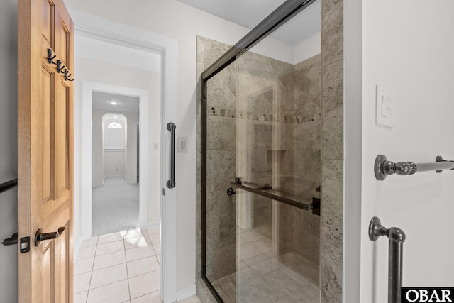 bathroom with a stall shower and tile patterned floors