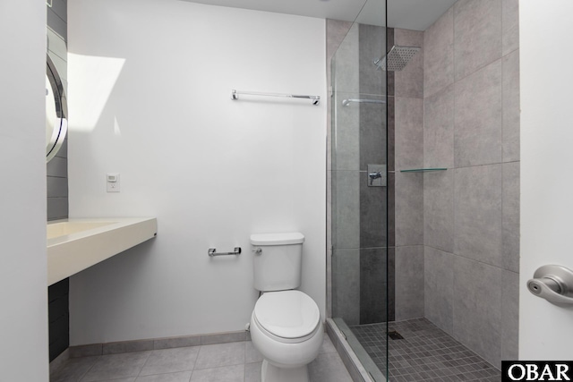 24 First Ave Lot # 14, Southern Shores, NC 27949 - full bathroom with toilet, tile patterned floors, a tile shower, and baseboards