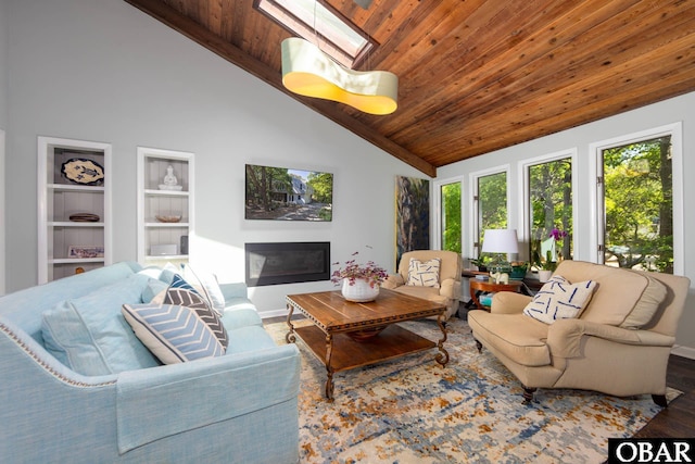 24 First Ave Lot # 14, Southern Shores, NC 27949 - living area with wood ceiling, built in shelves, baseboards, high vaulted ceiling, and a glass covered fireplace