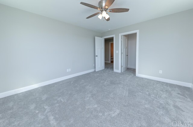 unfurnished bedroom featuring carpet, baseboards, and ceiling fan