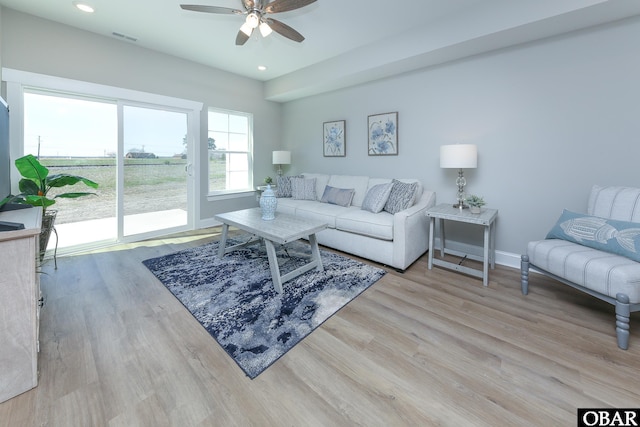 living room featuring ceiling fan, recessed lighting, visible vents, baseboards, and light wood finished floors