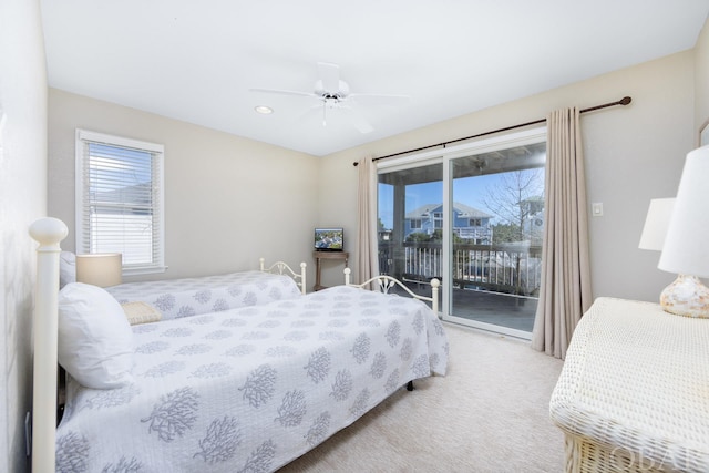 bedroom with ceiling fan, access to outside, and light colored carpet