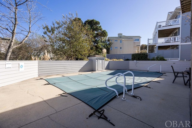 view of swimming pool with a patio area, fence, and a fenced in pool