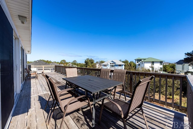 deck with a residential view and outdoor dining space