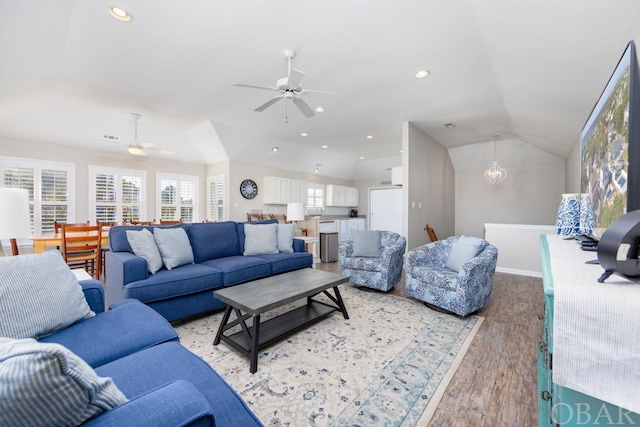 living room featuring lofted ceiling, light wood-style flooring, a ceiling fan, and recessed lighting