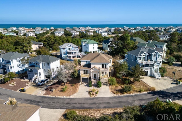 drone / aerial view featuring a residential view and a water view