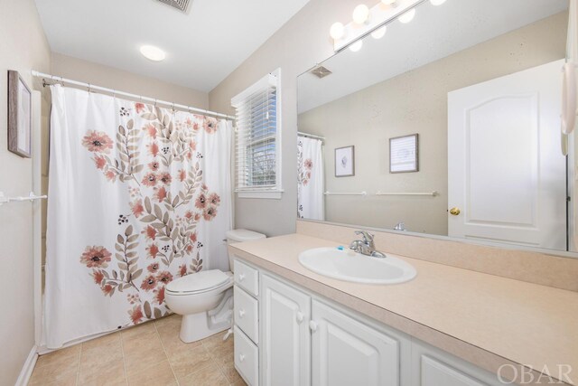 bathroom with a shower with shower curtain, tile patterned flooring, vanity, and toilet