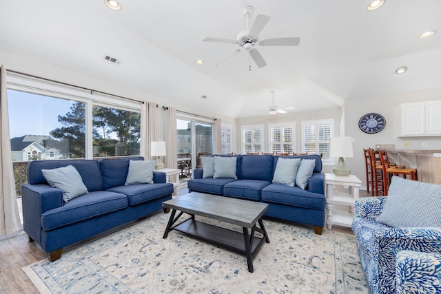 living room featuring light wood finished floors, visible vents, and recessed lighting