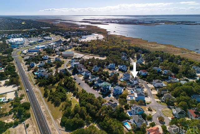 drone / aerial view with a water view and a residential view