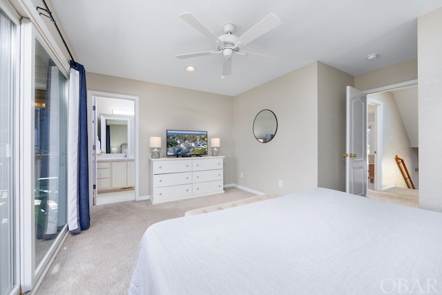 bedroom featuring connected bathroom, light carpet, a sink, a ceiling fan, and baseboards