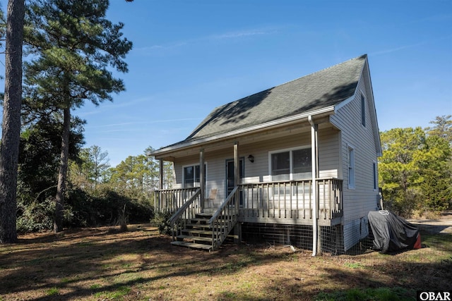 view of front of house with covered porch and roof with shingles