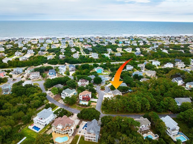 drone / aerial view featuring a residential view and a water view