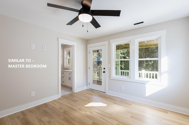 doorway with light wood-style flooring, baseboards, and ceiling fan