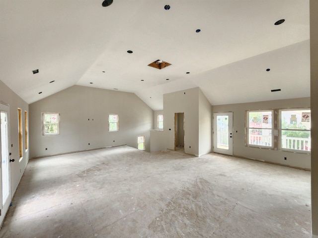 spare room with lofted ceiling and plenty of natural light