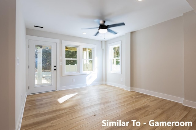 interior space featuring light wood-type flooring, ceiling fan, and baseboards