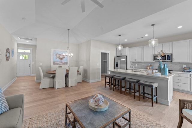 living room featuring visible vents, recessed lighting, light wood-style flooring, and baseboards