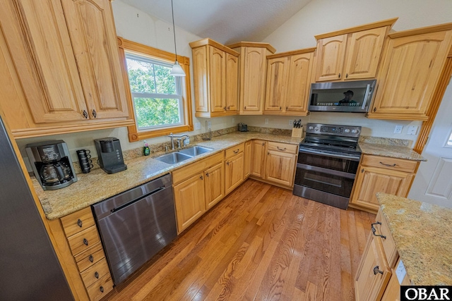 102 Settlers Ln Lot 7R, Duck, NC 27949 - kitchen with stainless steel appliances, vaulted ceiling, light wood-type flooring, hanging light fixtures, and light stone countertops