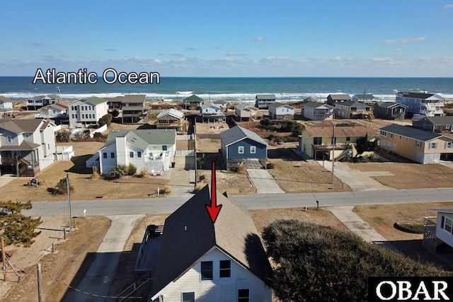 drone / aerial view with a water view and a residential view