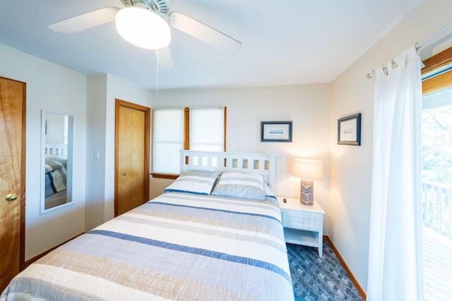 bedroom with a ceiling fan, dark carpet, and baseboards