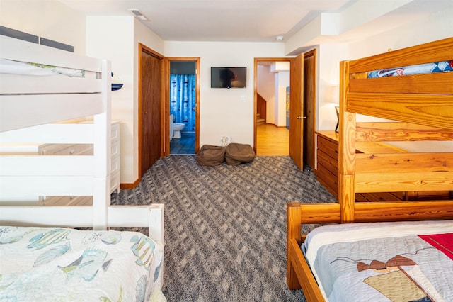 bedroom with visible vents and connected bathroom