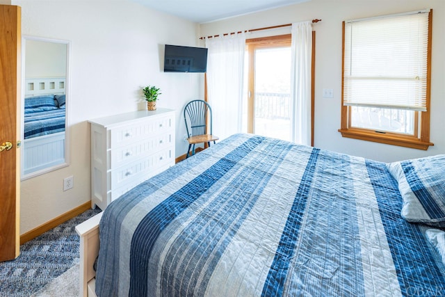 bedroom with carpet floors and baseboards