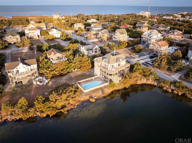 birds eye view of property featuring a water view and a residential view