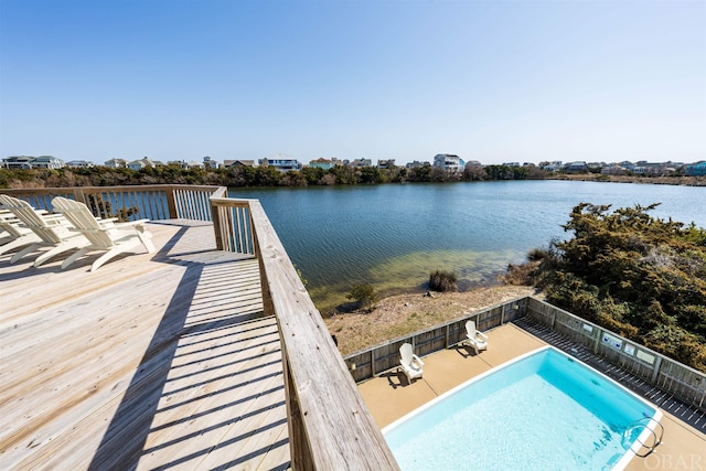 dock area featuring a fenced in pool and a water view