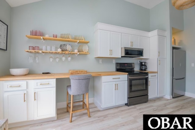 131B Jay Crest Rd Unit 801, Duck, NC 27949 - kitchen featuring stainless steel appliances, light wood-type flooring, white cabinetry, and wooden counters