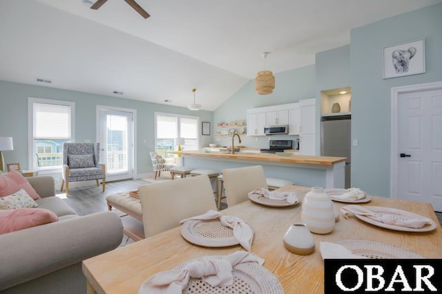 131B Jay Crest Rd Unit 801, Duck, NC 27949 - dining space featuring vaulted ceiling, wood finished floors, and a ceiling fan
