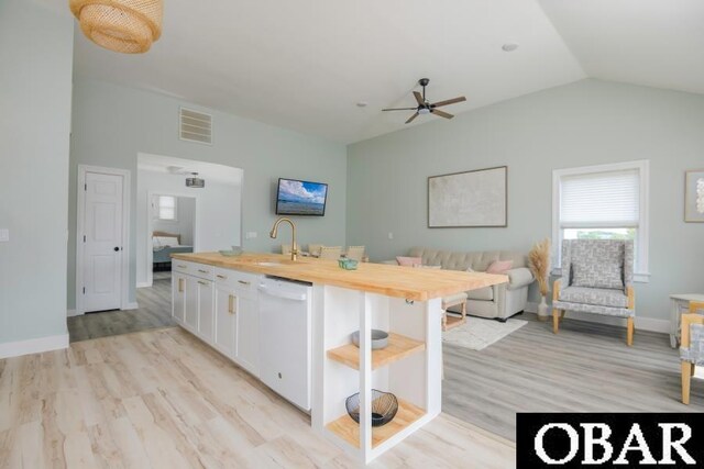 131B Jay Crest Rd Unit 801, Duck, NC 27949 - kitchen with white dishwasher, butcher block counters, lofted ceiling, open floor plan, and white cabinetry