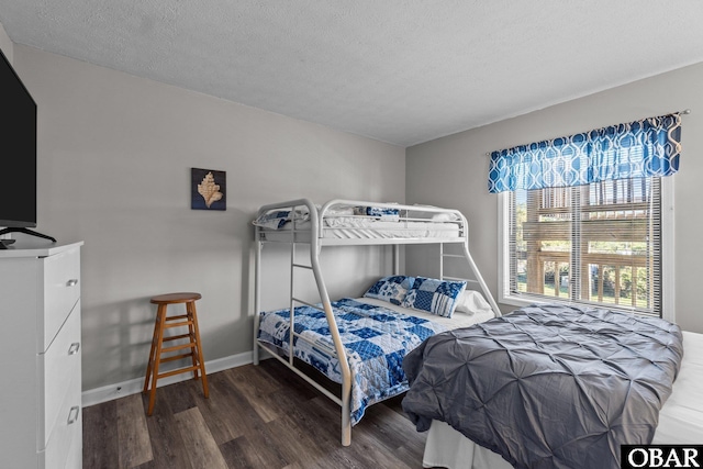 627 Sand Fiddler Cir Unit B-1, Corolla, NC 27927 - bedroom featuring wood finished floors and a textured ceiling
