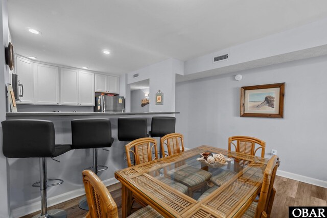 627 Sand Fiddler Cir Unit B-1, Corolla, NC 27927 - dining room featuring wood finished floors and recessed lighting