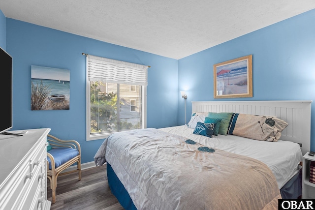 627 Sand Fiddler Cir Unit B-1, Corolla, NC 27927 - bedroom featuring dark wood-style floors and a textured ceiling