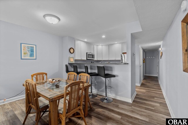 627 Sand Fiddler Cir Unit B-1, Corolla, NC 27927 - dining area featuring wood finished floors and recessed lighting