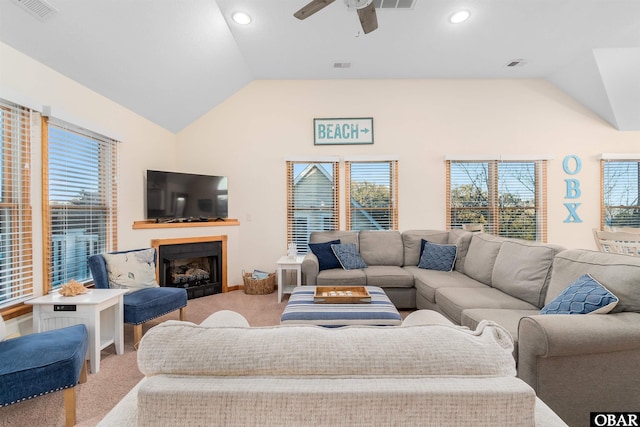 carpeted living area featuring visible vents, ceiling fan, and lofted ceiling