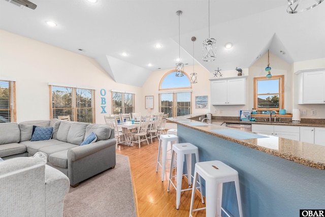 interior space featuring recessed lighting, light wood-style floors, visible vents, and high vaulted ceiling