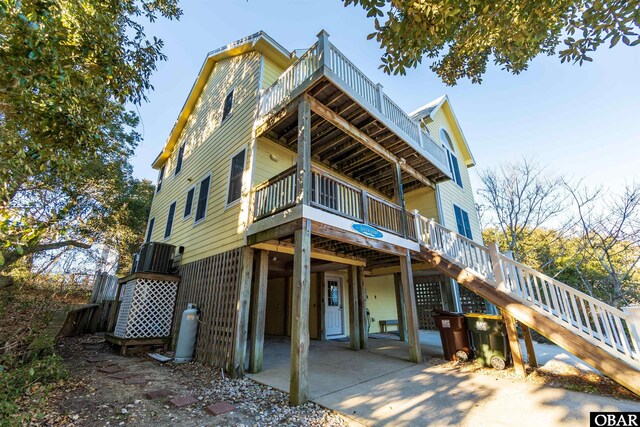 757 Fishermans Ct Lot 66, Corolla, NC 27927 - view of front facade with stairway, cooling unit, and a wooden deck