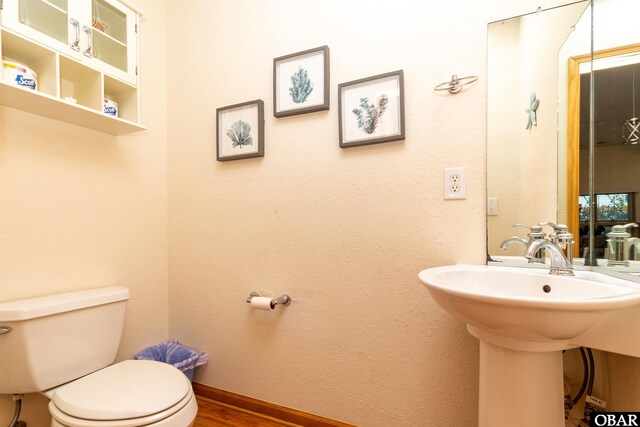 757 Fishermans Ct Lot 66, Corolla, NC 27927 - half bath with a sink, baseboards, toilet, and wood finished floors