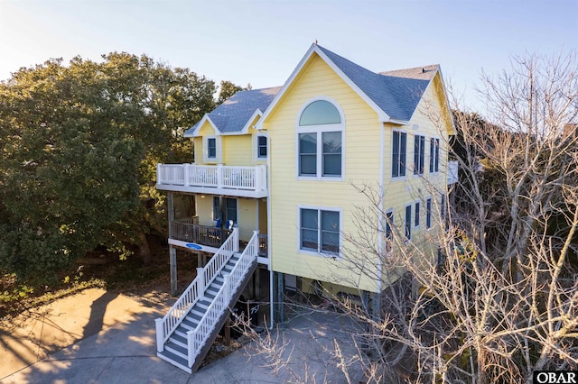 757 Fishermans Ct Lot 66, Corolla, NC 27927 - view of front of house featuring stairs, a porch, a carport, and a shingled roof